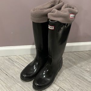 Black glossy tall hunter boots. Worn but in good condition with socks.
